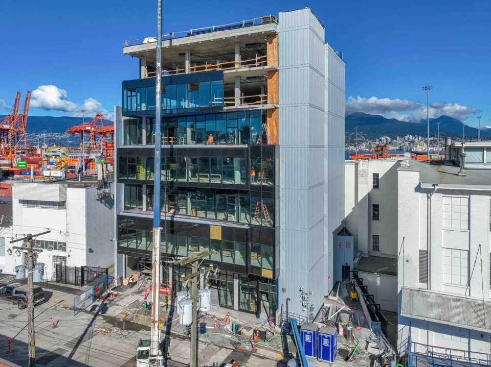 Multi-storey building under construction with glazing and exposed upper floors