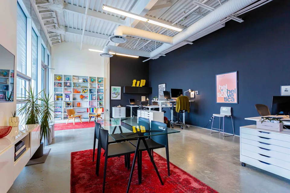 Creative studio with a glass table and tall windows