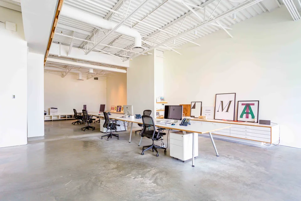 Bright open workspace with exposed white ceilings