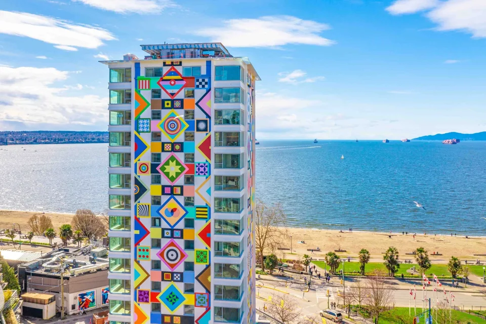 A colourful residential tower beside the ocean