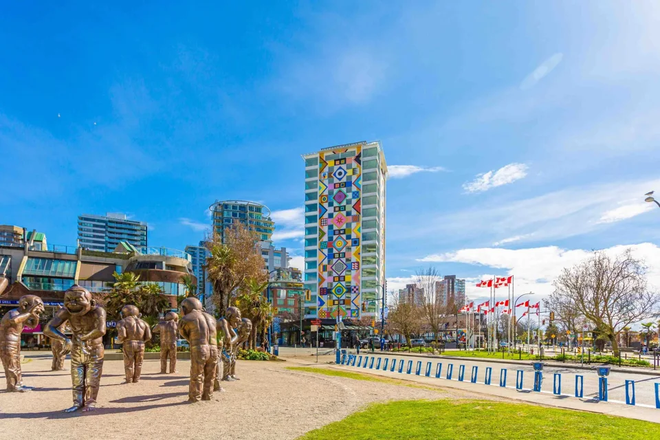 Colourful residential tower above a public plaza at English Bay