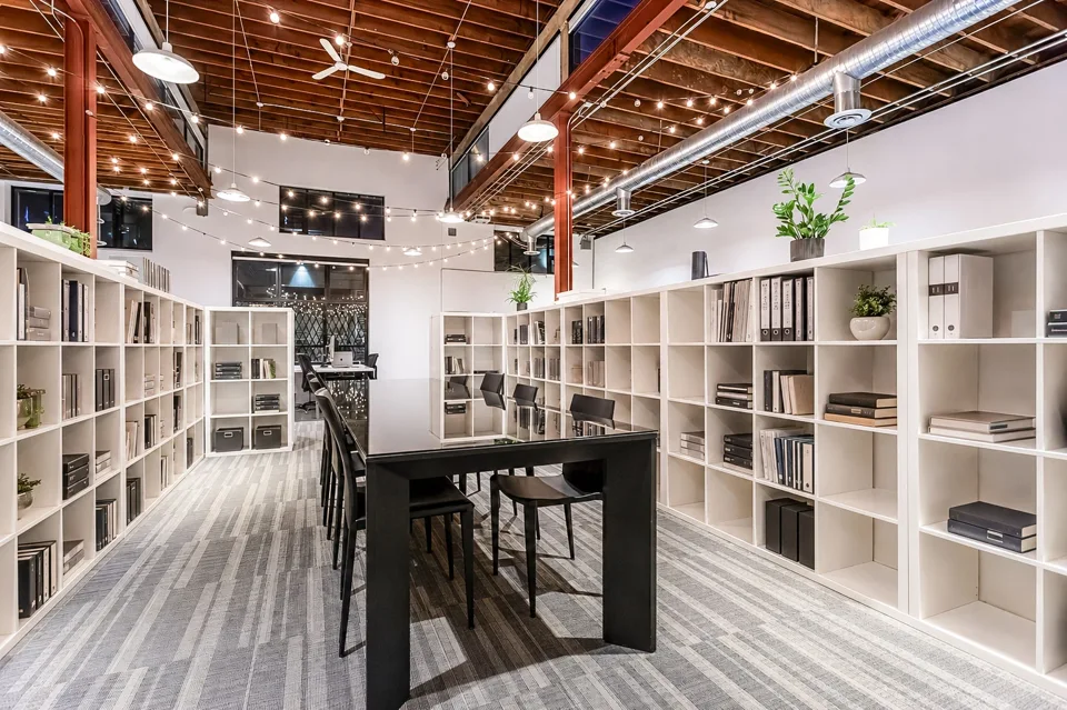 Open interior with bookshelves and exposed timber ceilings